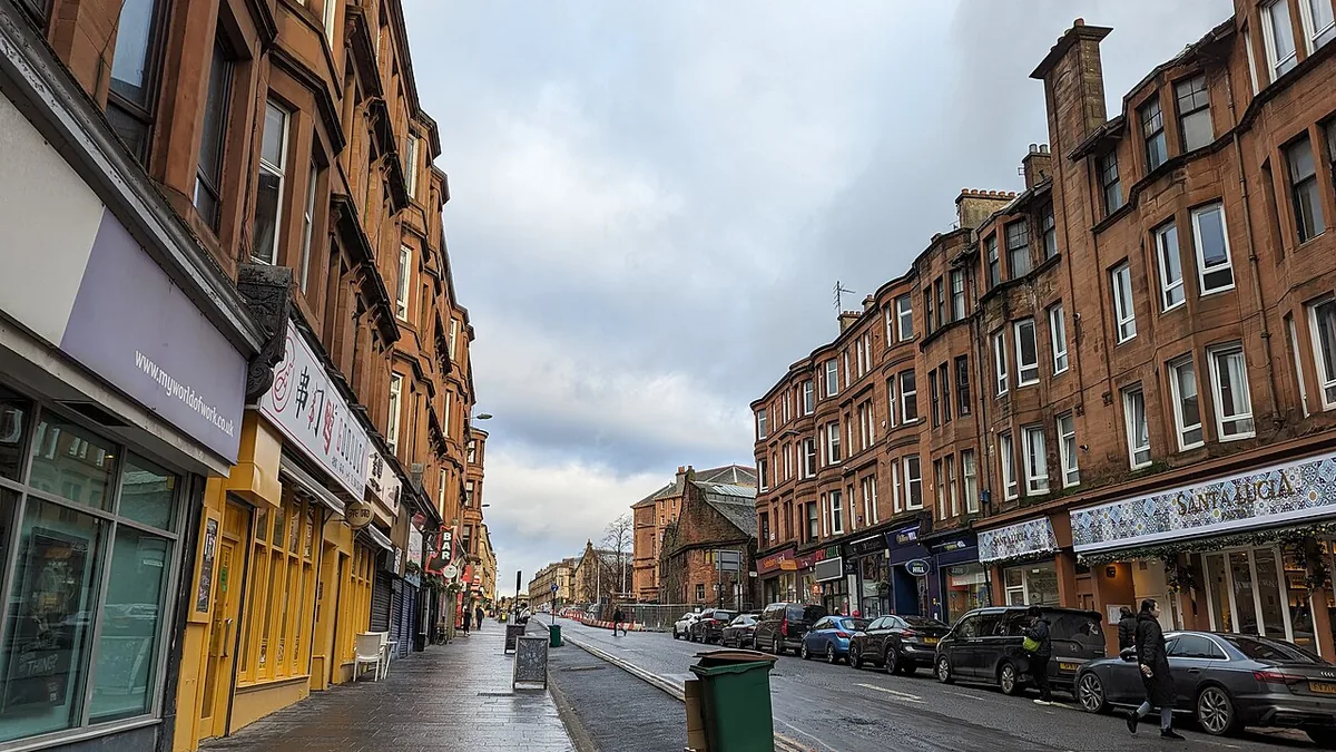 Glasgow West End blonde sandstone tenements with University of Glasgow spire in background